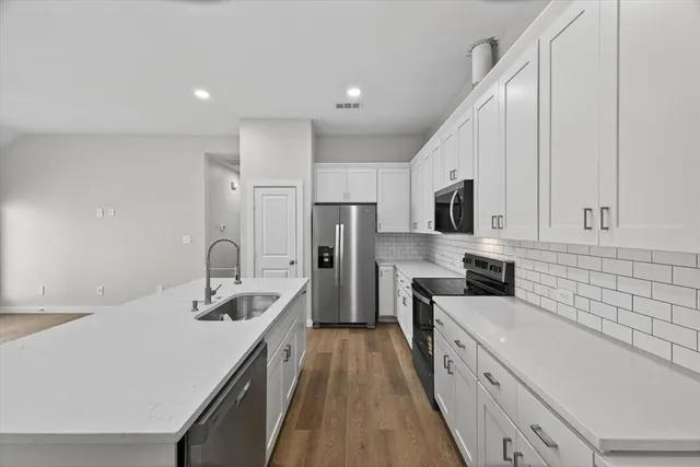 a kitchen with a sink and cabinets