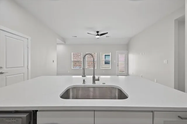 a kitchen with appliances a sink and cabinets
