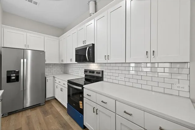 a view of white cabinets and window