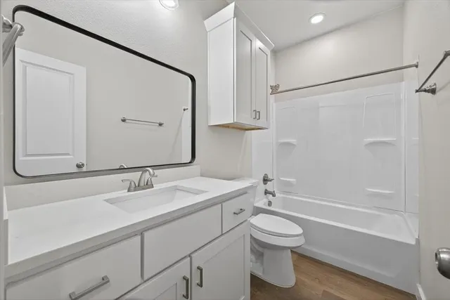 a white toilet sitting next to a bathroom sink and a shower