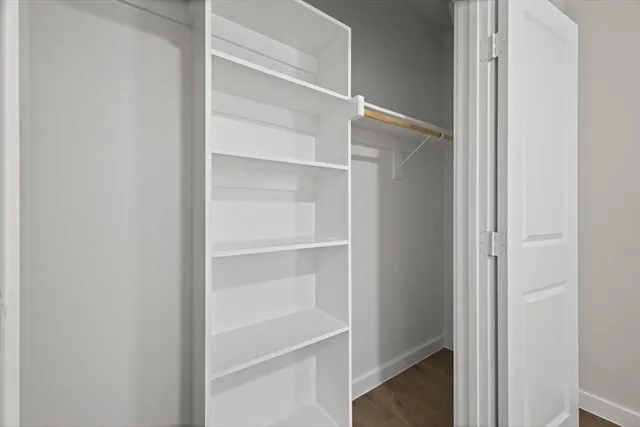 a view of walk in closet with empty racks
