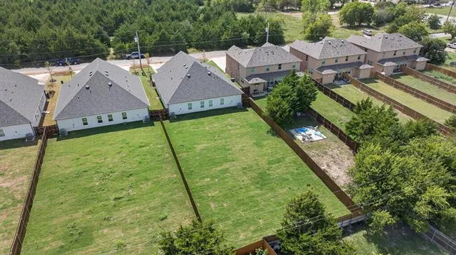 an aerial view of residential houses with outdoor space