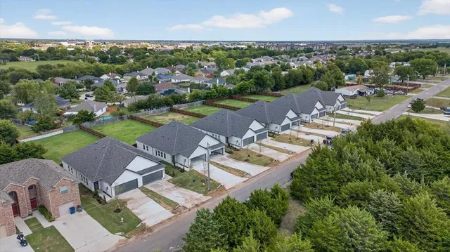 an aerial view of residential houses with outdoor space