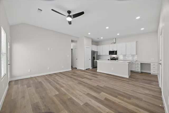 a view of kitchen with wooden floor and electronic appliances