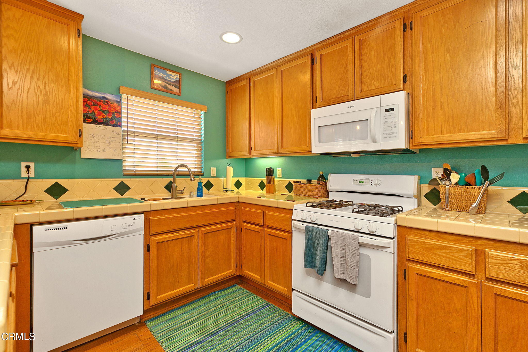 11172 Darling Road Ventura, CA 93004 - Photo 14 of 31 a kitchen with a sink stove and cabinets