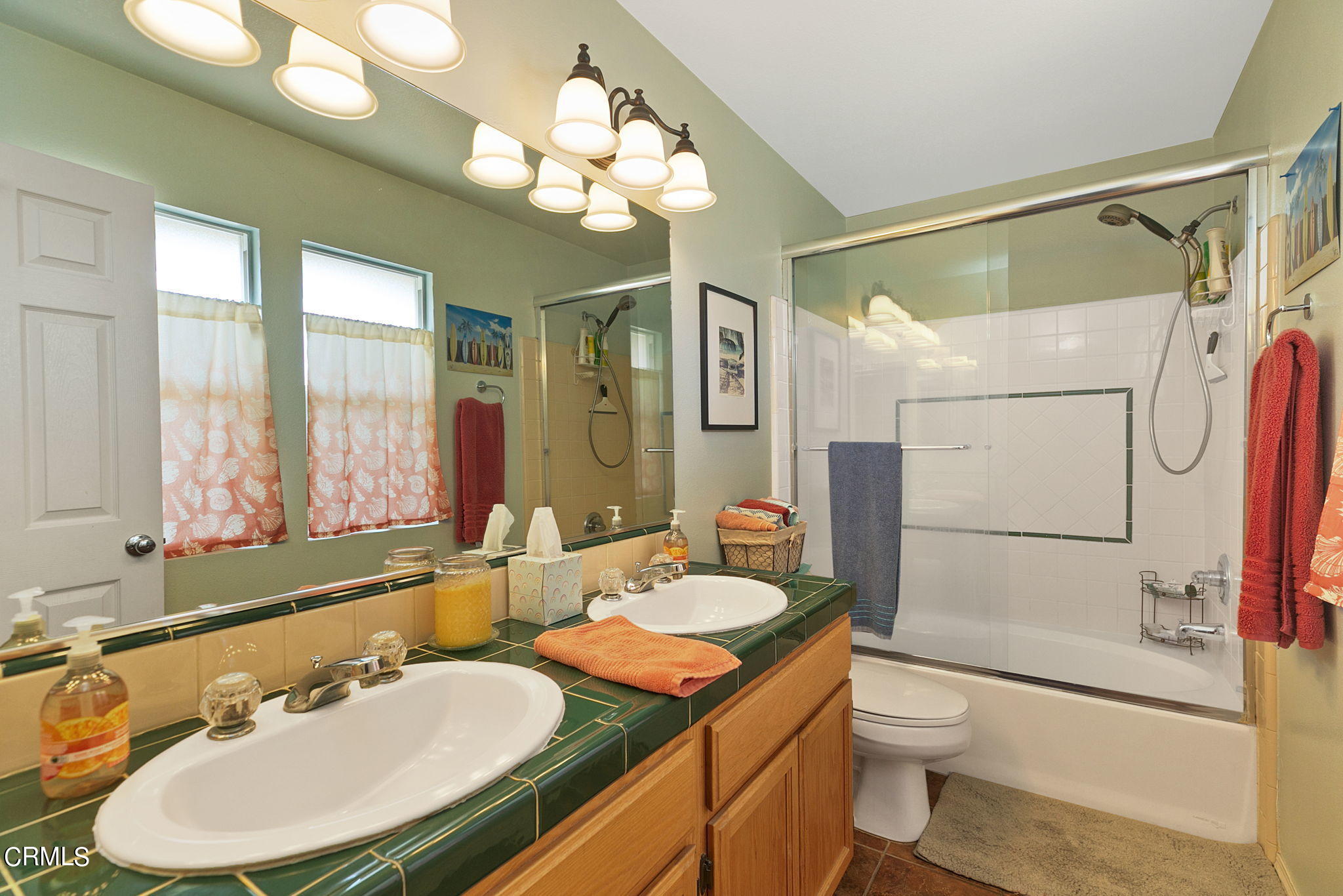 11172 Darling Road Ventura, CA 93004 - Photo 24 of 31 a bathroom with a sink a toilet a mirror a bathtub and shower