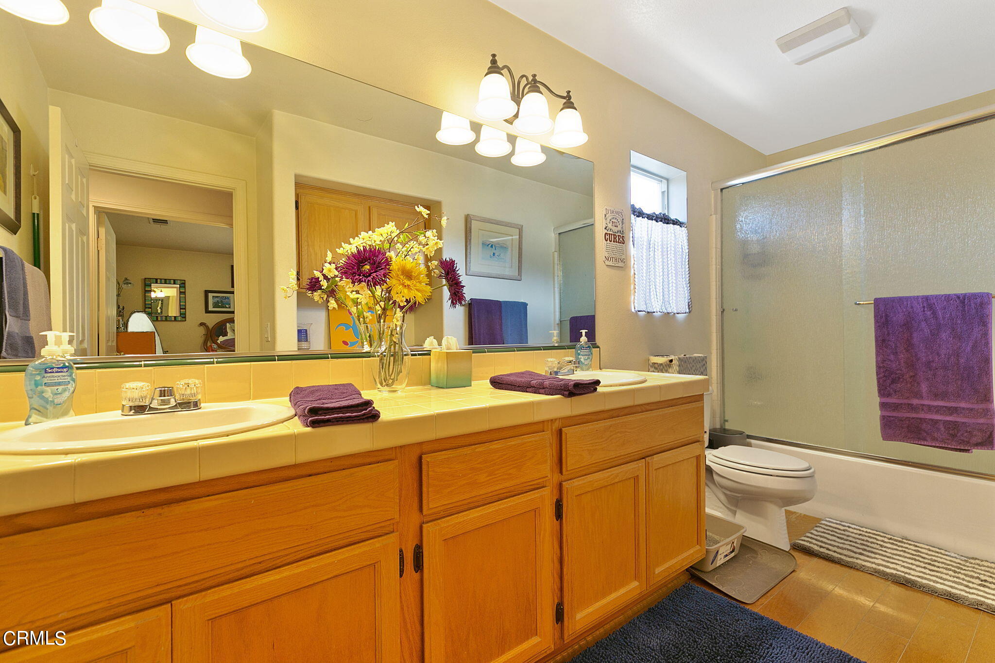 11172 Darling Road Ventura, CA 93004 - Photo 27 of 31 a bathroom with a double vanity sink mirror and toilet