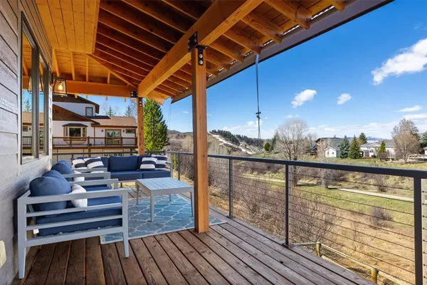 a view of a balcony with couches and wooden floor