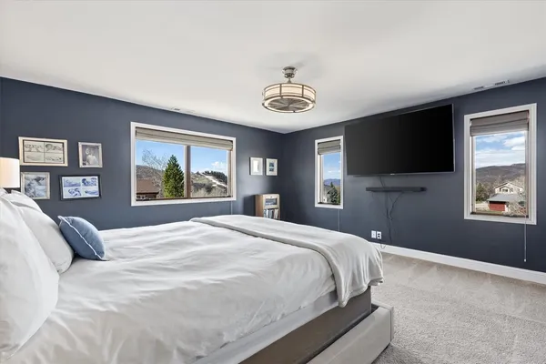 a spacious bedroom with a bed and a table in it