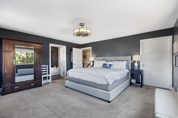 a bedroom with a bed and lamp on table