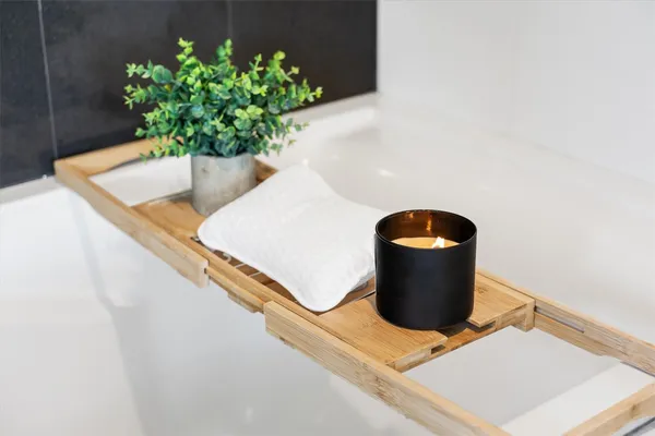 a bedroom with a bed a flat screen tv and chandelier