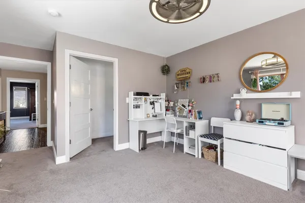 a bathroom with a granite countertop sink a toilet and mirror