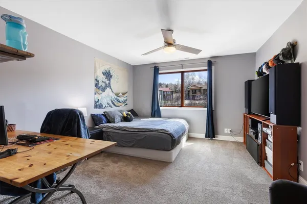 a bedroom with a bed lamps and chairs