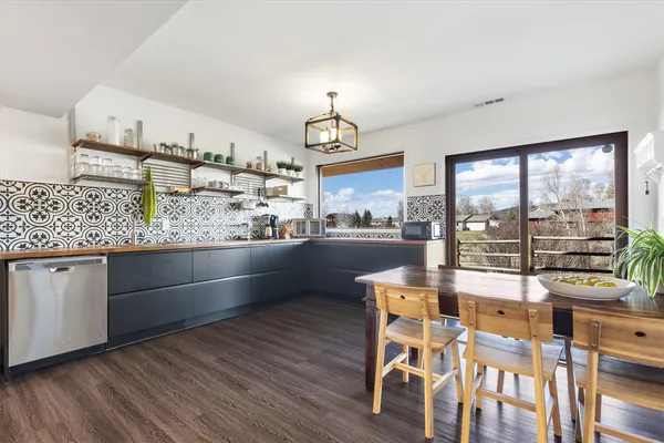 a kitchen with stainless steel appliances granite countertop a stove and a wooden floors