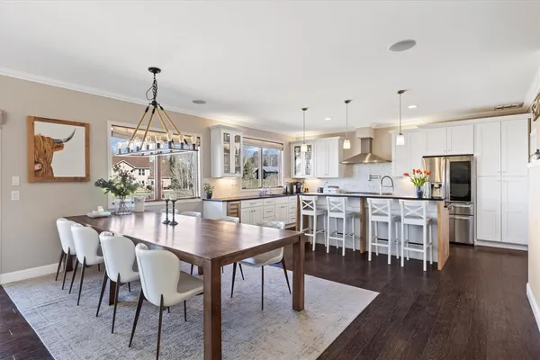 a view of a dining room and livingroom with furniture wooden floor