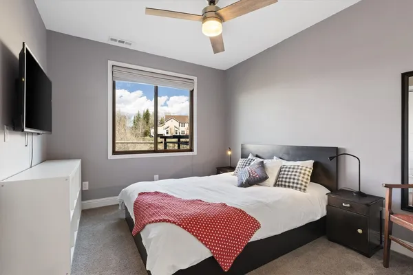 a bathroom with a sink a toilet a large mirror and shower