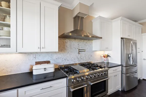 a kitchen with a stove and a refrigerator