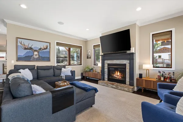 a living room with furniture a flat screen tv and a fireplace