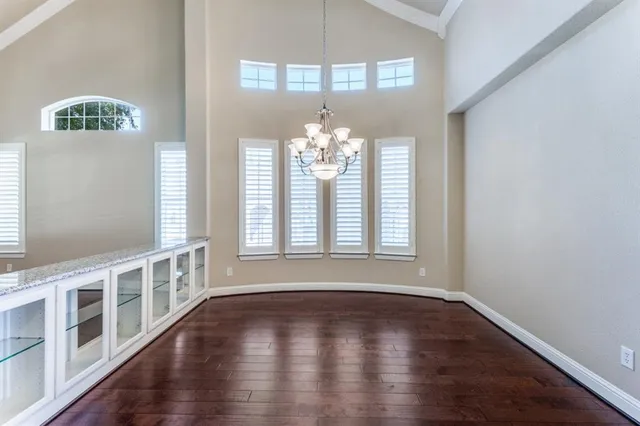 a view of a kitchen with cabinets and wooden floor