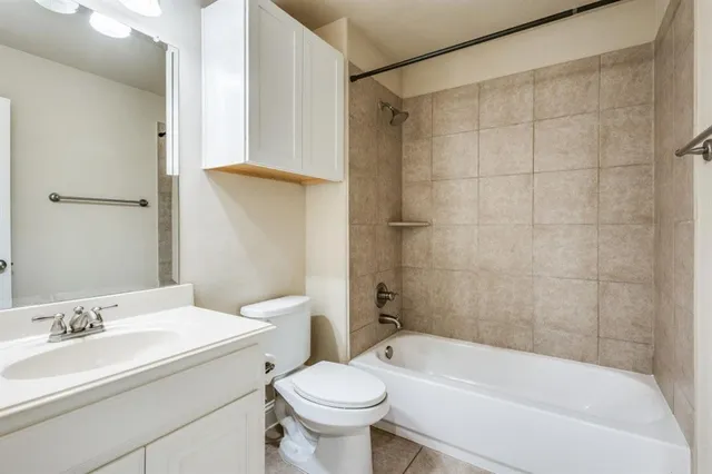 a bathroom with a sink a toilet and a bathtub