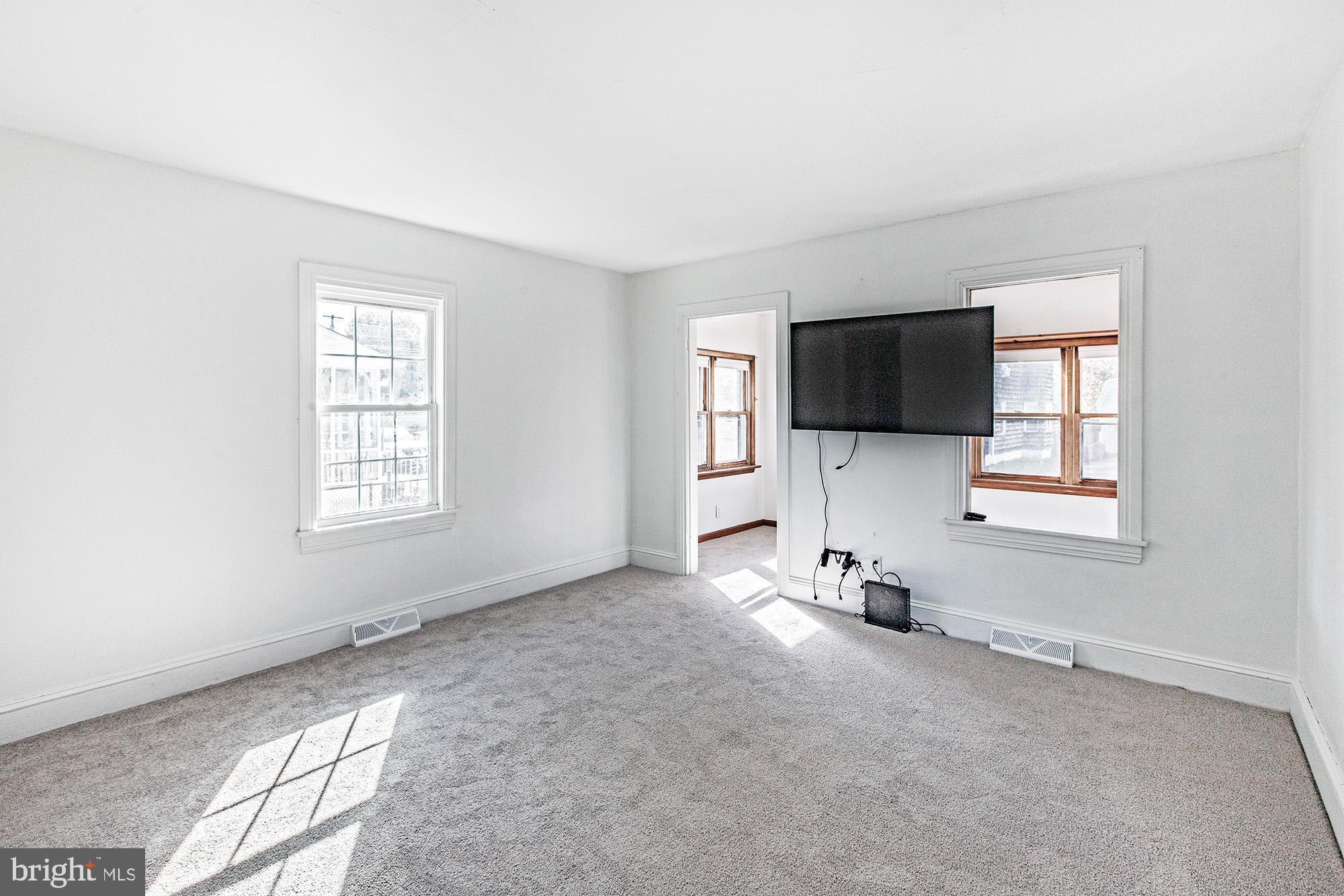 56 Main Street Hancocks Bridge, NJ 08038 - Photo 11 of 33 an empty room with windows and tv