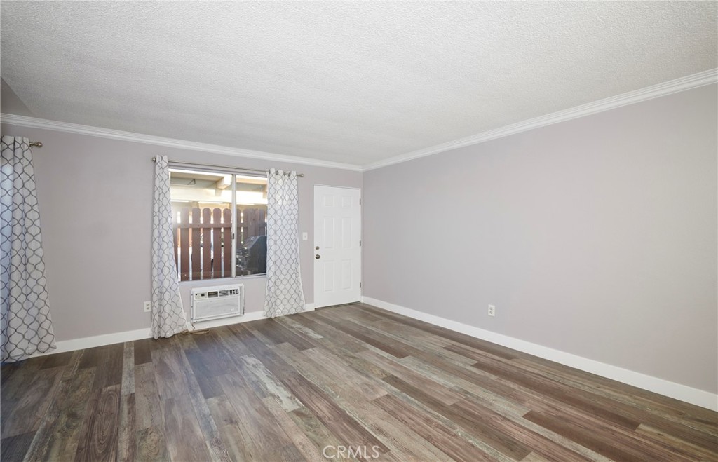 4723 Jackson Street, Unit 28 Riverside, CA 92503 - Photo 15 of 33 wooden floor in an empty room with a window