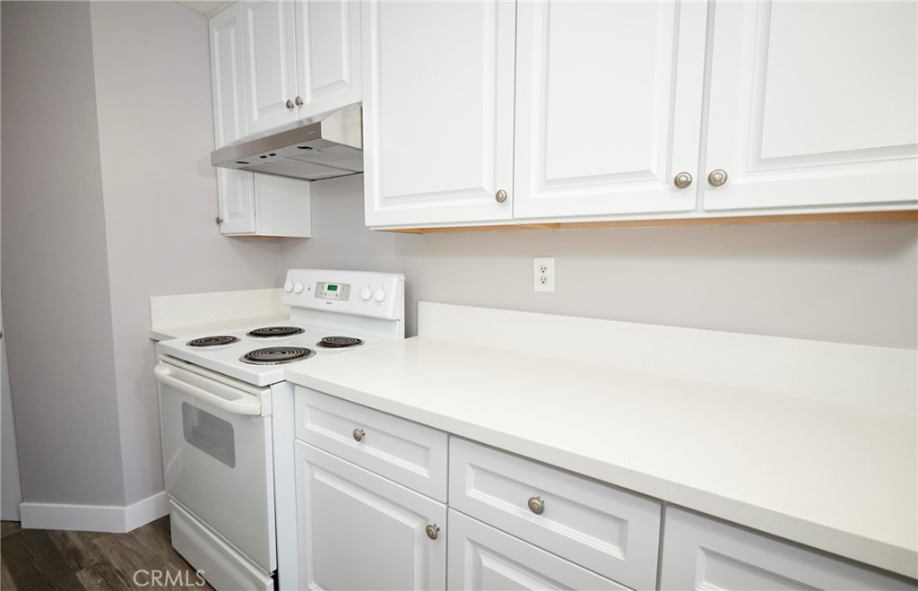 4723 Jackson Street, Unit 28 Riverside, CA 92503 - Photo 18 of 33 a kitchen with white cabinets and white appliances