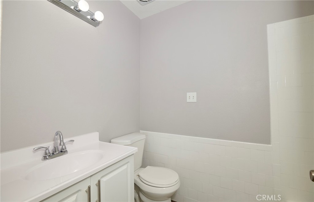 4723 Jackson Street, Unit 28 Riverside, CA 92503 - Photo 21 of 33 a bathroom with a sink a toilet and vanity