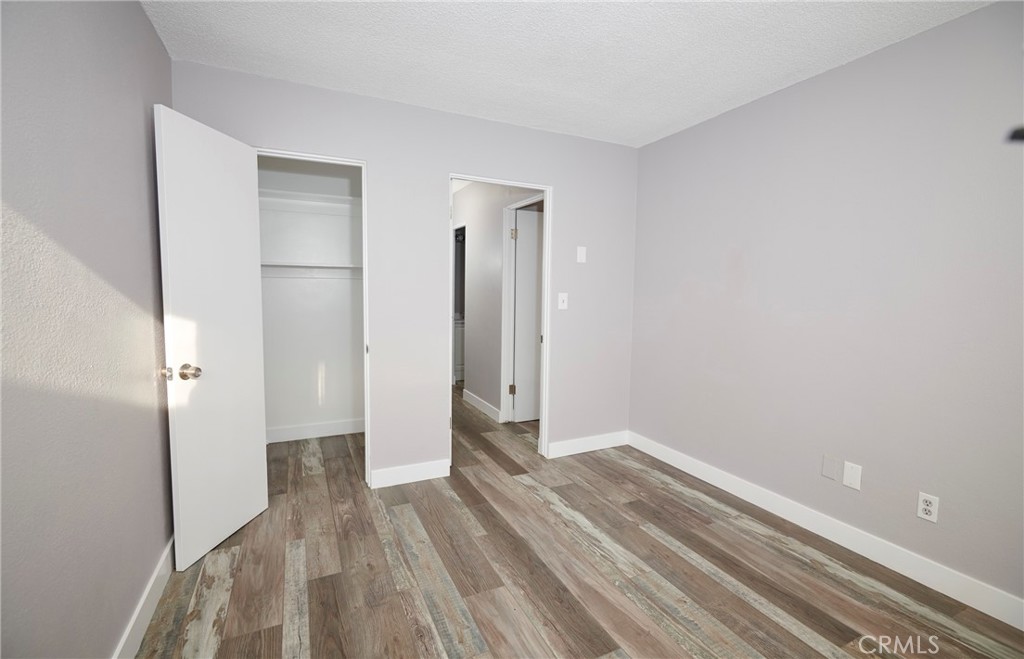 4723 Jackson Street, Unit 28 Riverside, CA 92503 - Photo 23 of 33 a view of hallway with closet and wooden floor