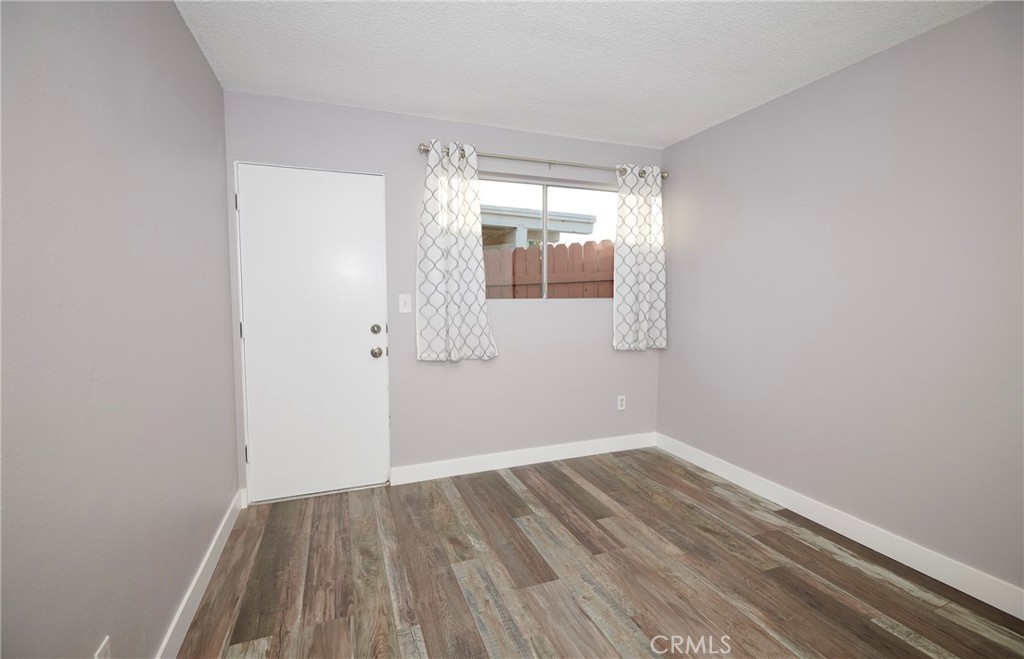 4723 Jackson Street, Unit 28 Riverside, CA 92503 - Photo 24 of 33 a view of wooden floor and chandelier in a room
