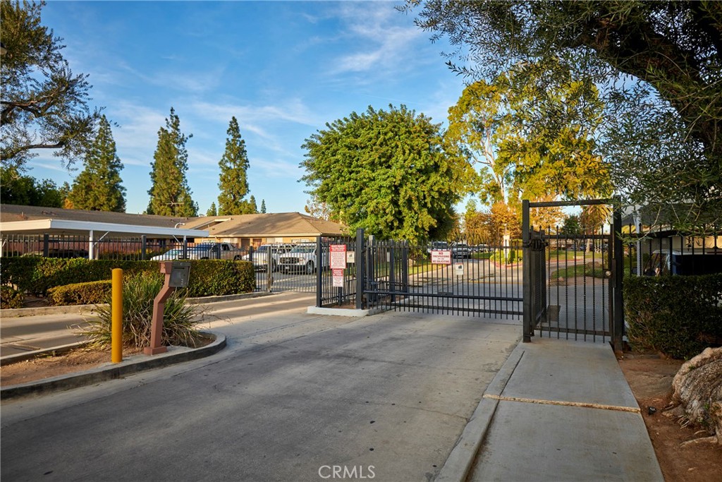 4723 Jackson Street, Unit 28 Riverside, CA 92503 - Photo 33 of 33 a view of a patio with table and chairs and a large tree