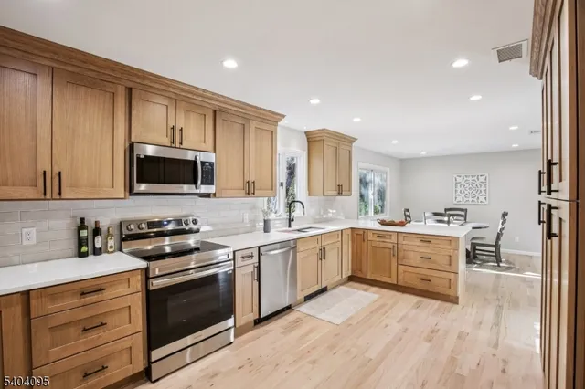 a kitchen with a sink stove and microwave