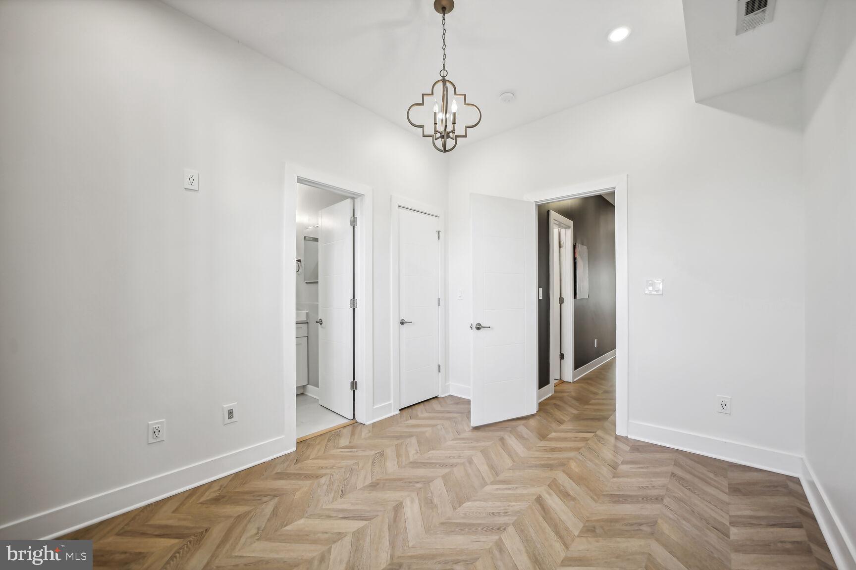 2012 D Street Northeast, Unit 3 Washington, DC 20002 - Photo 14 of 20 a view of a room with wooden floor and chandelier