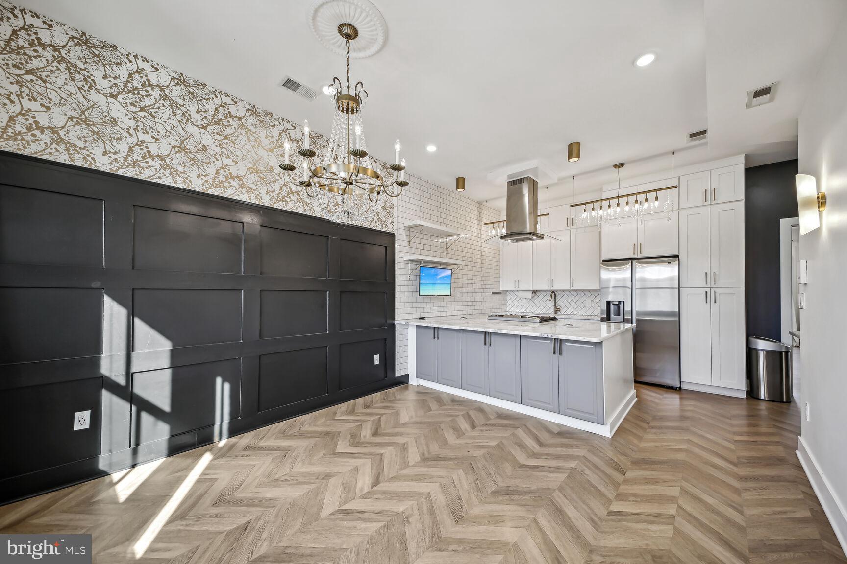 2012 D Street Northeast, Unit 3 Washington, DC 20002 - Photo 2 of 20 a kitchen with stainless steel appliances kitchen island granite countertop a refrigerator and a sink