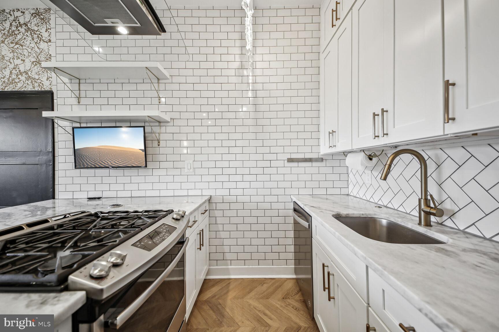 2012 D Street Northeast, Unit 3 Washington, DC 20002 - Photo 5 of 20 a kitchen that has a sink and a stove