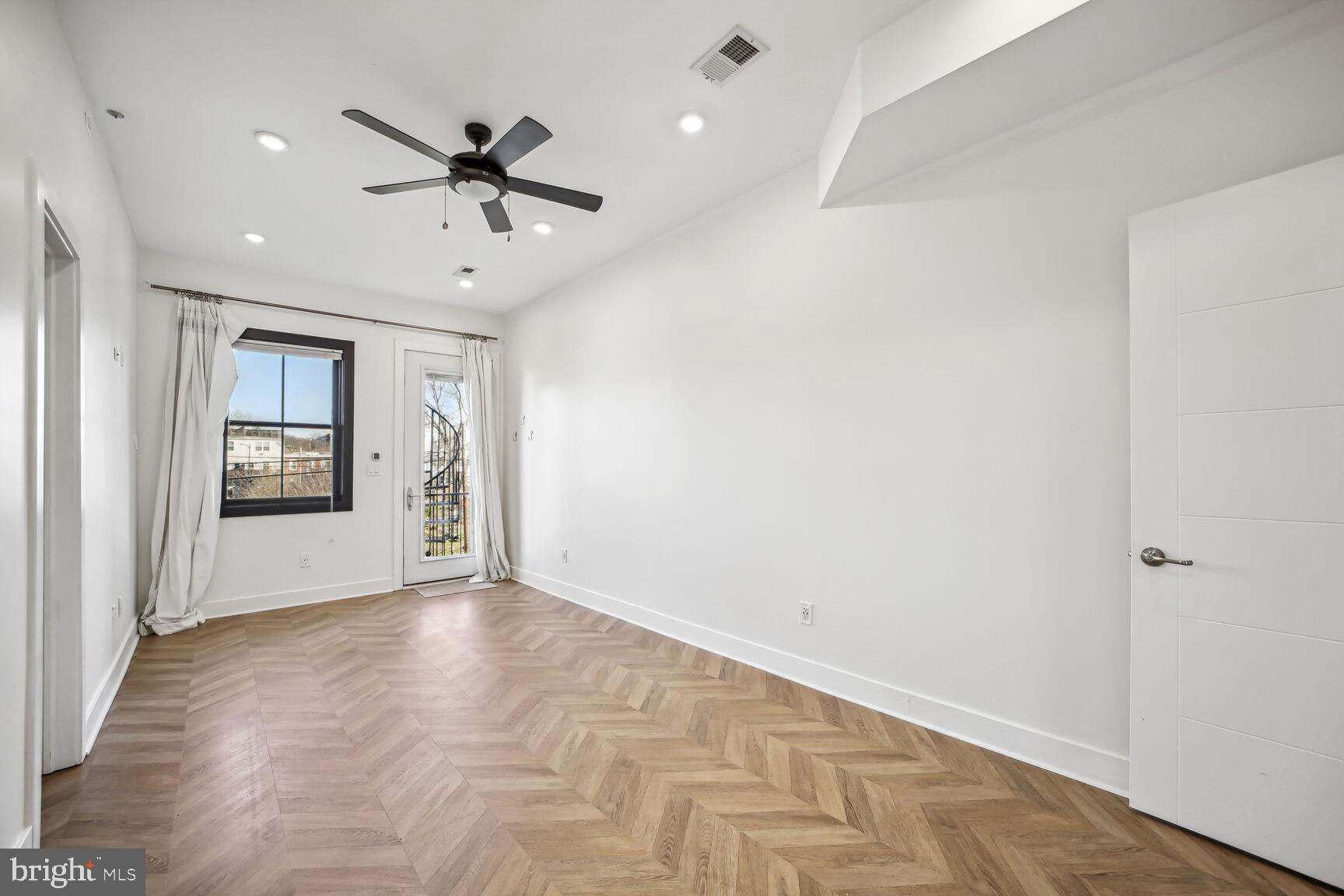 2012 D Street Northeast, Unit 3 Washington, DC 20002 - Photo 7 of 20 wooden floor in an empty room with a window