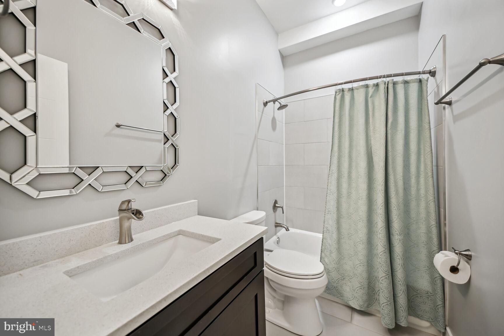 2012 D Street Northeast, Unit 3 Washington, DC 20002 - Photo 9 of 20 a bathroom with a sink a toilet and shower