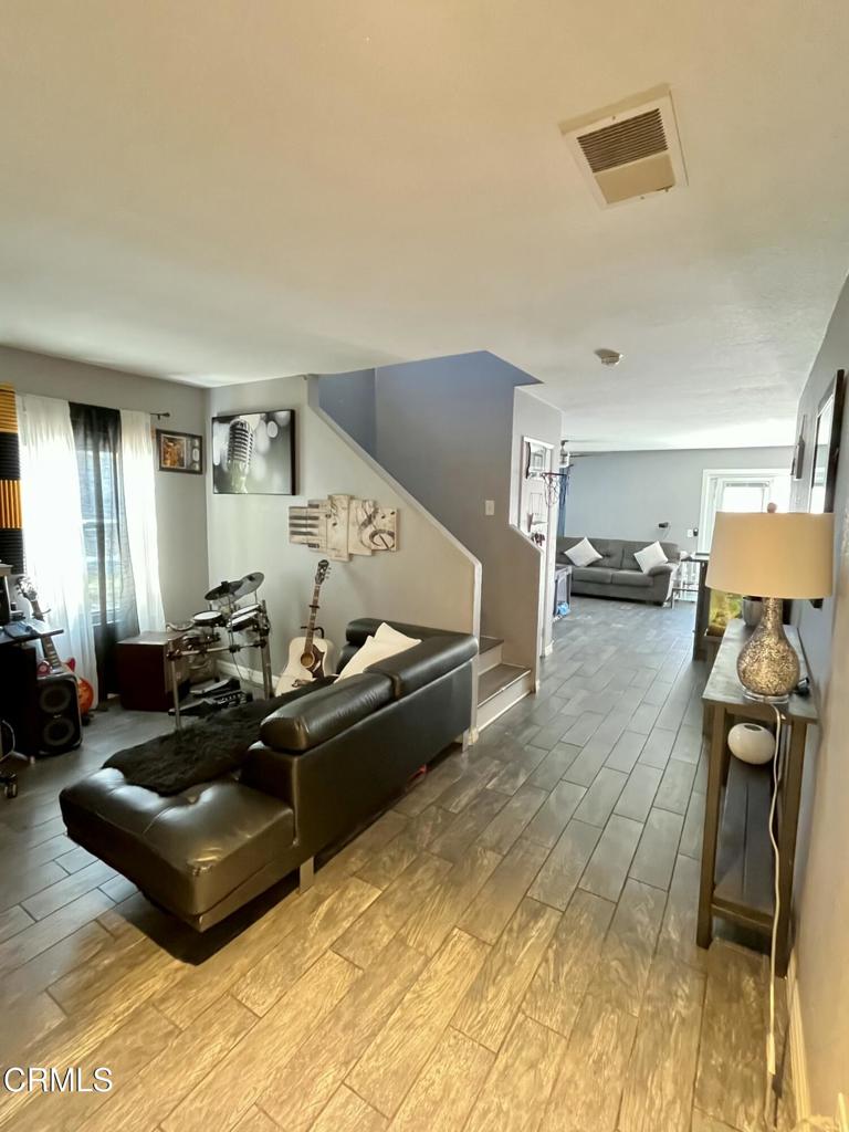 40339 Pantano Road Palmdale, CA 93550 - Photo 2 of 11 a living room with furniture and a flat screen tv