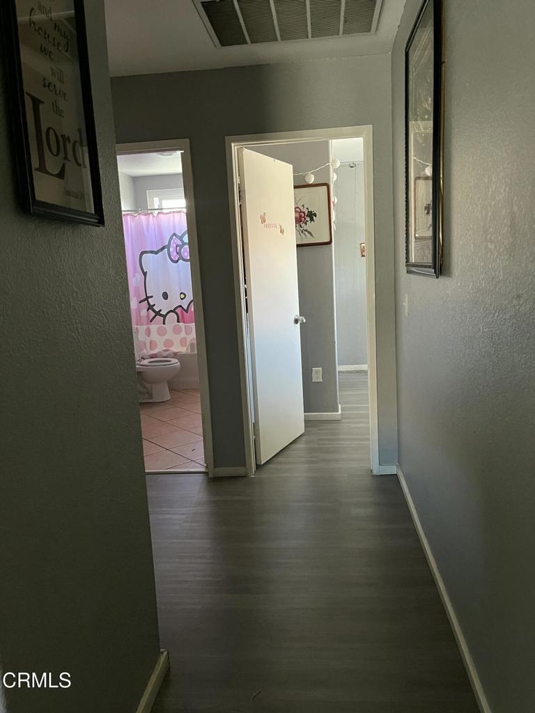 40339 Pantano Road Palmdale, CA 93550 - Photo 8 of 11 a view of hallway with wooden floor