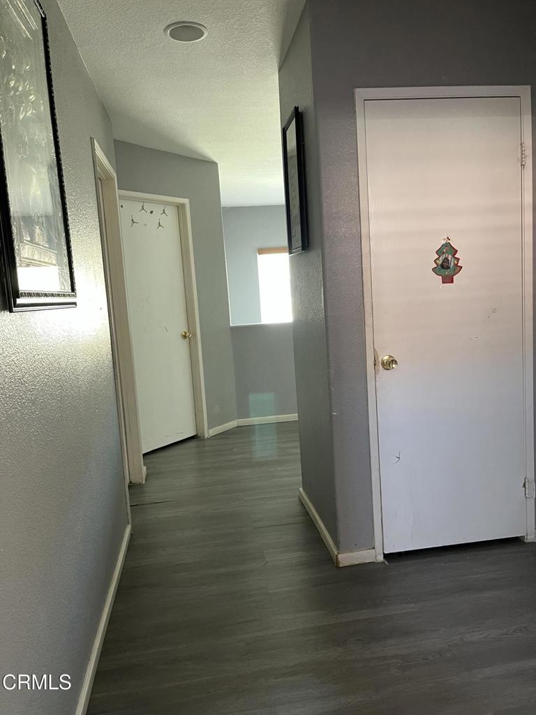 40339 Pantano Road Palmdale, CA 93550 - Photo 9 of 11 an empty room with wooden floor and mirror