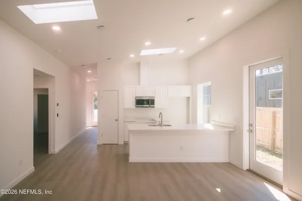 a bathroom with a sink a bathtub and a window