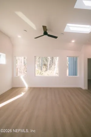 an empty room with a empty space and windows