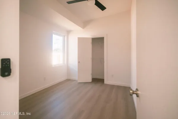a view of a small space with wooden floor and a bathroom