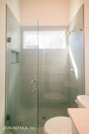 a bathroom with a glass shower door