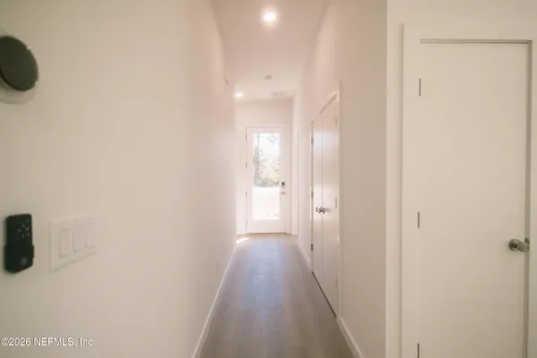 a view of a hallway with wooden floor