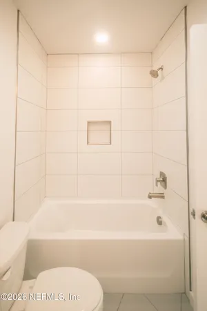 a bathroom with a bathtub and a toilet