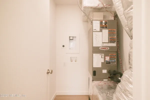 a view of a bathroom with a shower and a room
