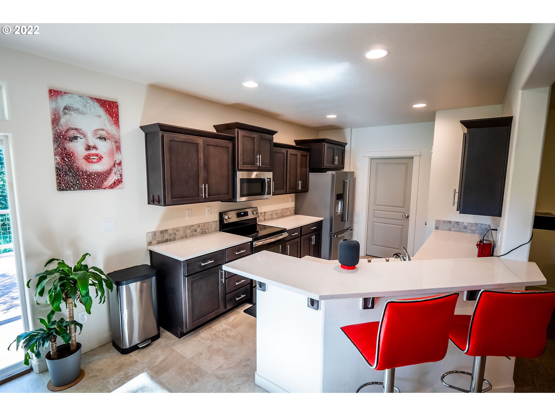 1345 Skyline Park Loop Eugene, OR 97405 - Photo 3 of 31 a kitchen with stainless steel appliances kitchen island granite countertop a refrigerator and a sink