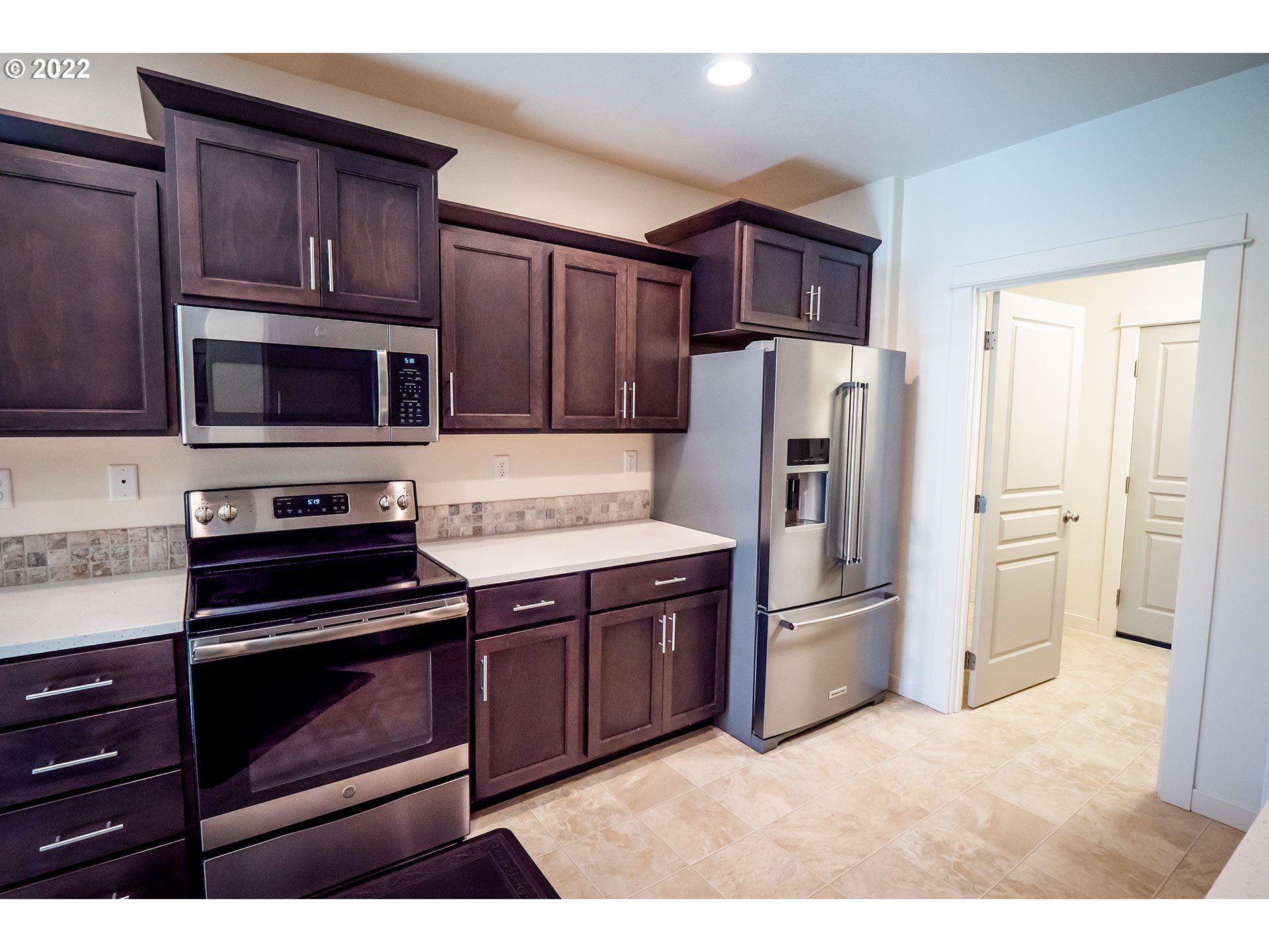 1345 Skyline Park Loop Eugene, OR 97405 - Photo 5 of 31 a kitchen with stainless steel appliances and stove top oven