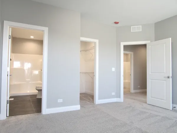 an empty room with a bathroom and a sink